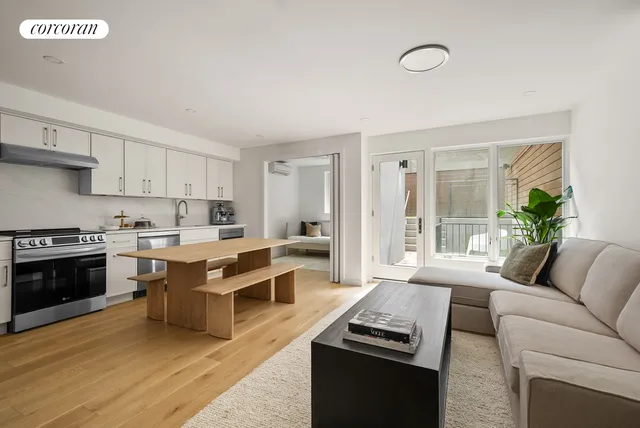 a kitchen with stainless steel appliances kitchen island granite countertop a stove top oven a sink dishwasher a dining table and chairs with wooden floor