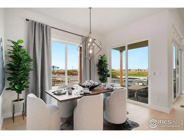 a dining room with furniture water view and a floor to ceiling window