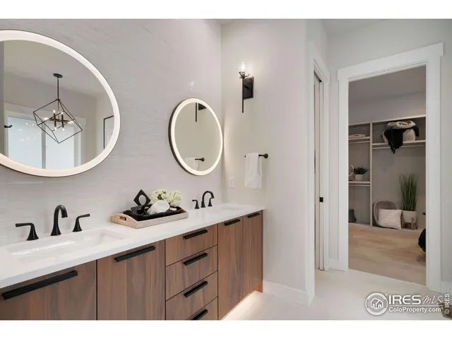 a bathroom with a double vanity sink and a mirror