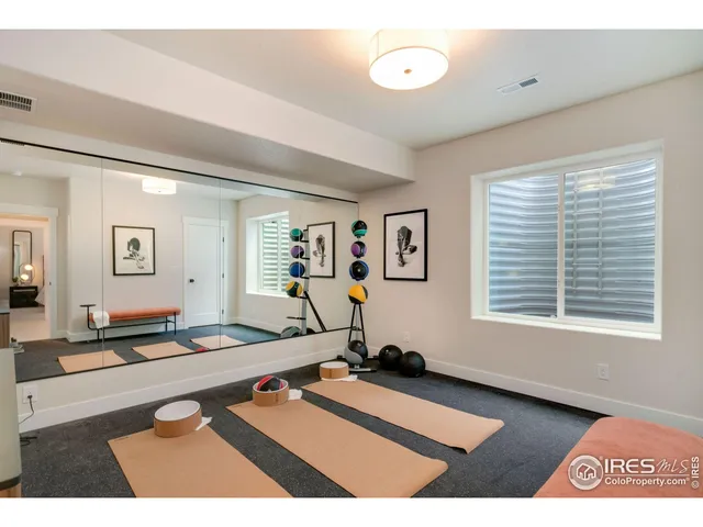 a room with gym equipment and a large window
