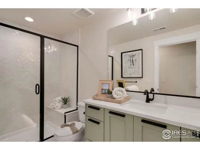 a bathroom with a sink a mirror and shower