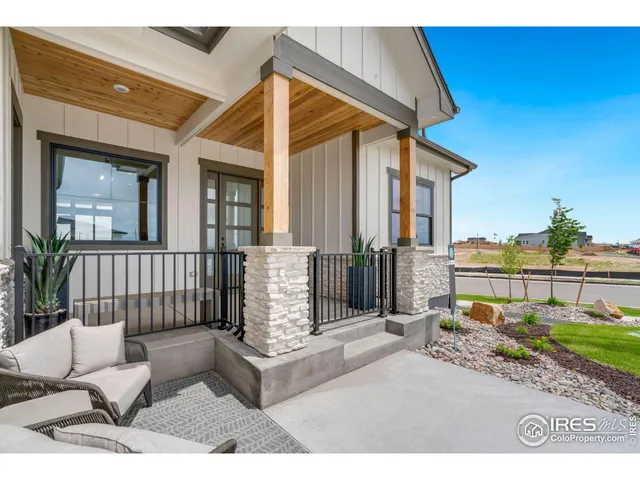 a view of a house with a small yard and wooden fence