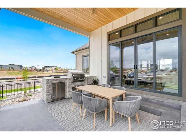 a dining room with furniture and a floor to ceiling window
