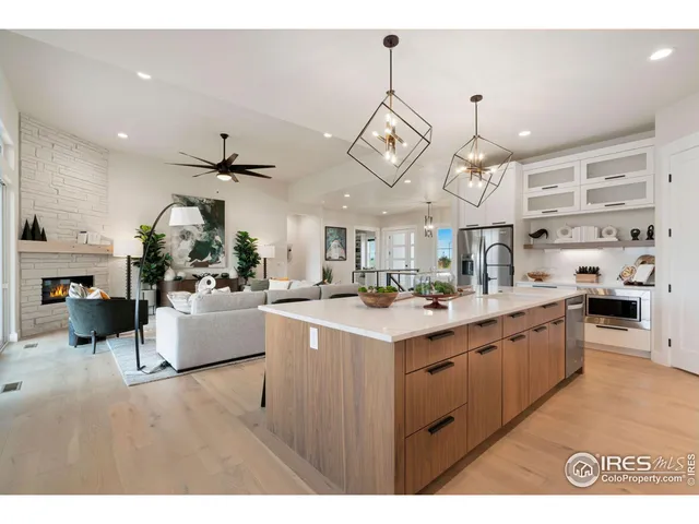a kitchen with stainless steel appliances a lot of counter space and a chandelier