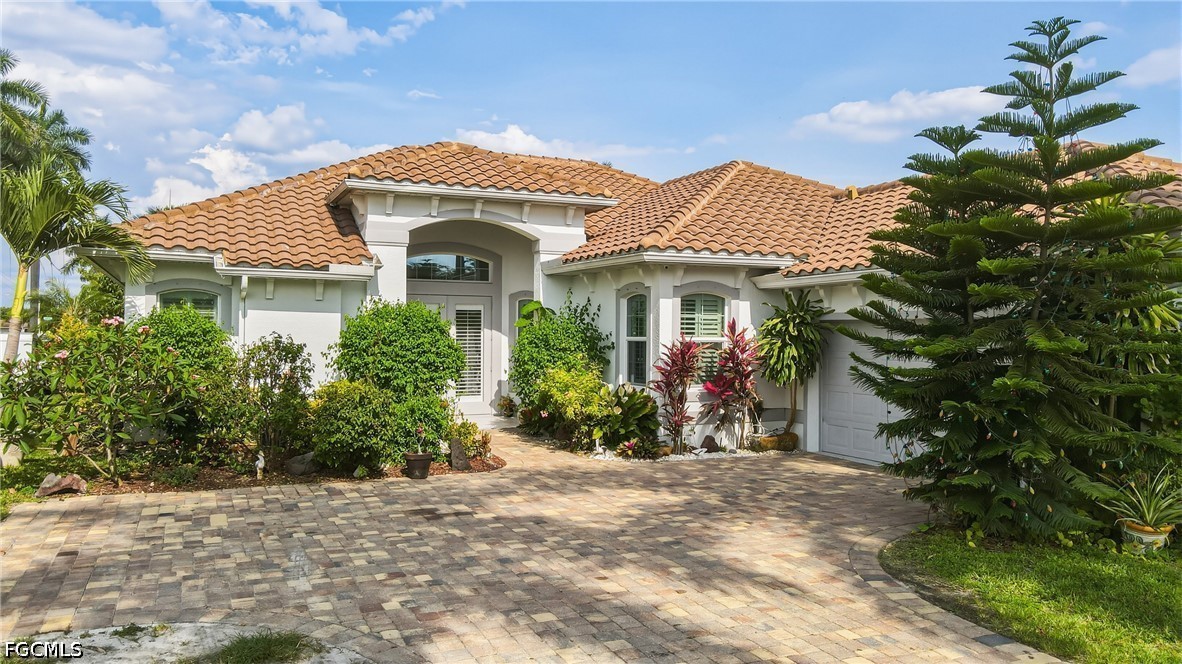 1700 43rd Terrace Southwest Naples, FL 34116 - Photo 6 of 38 a front view of a house with a yard