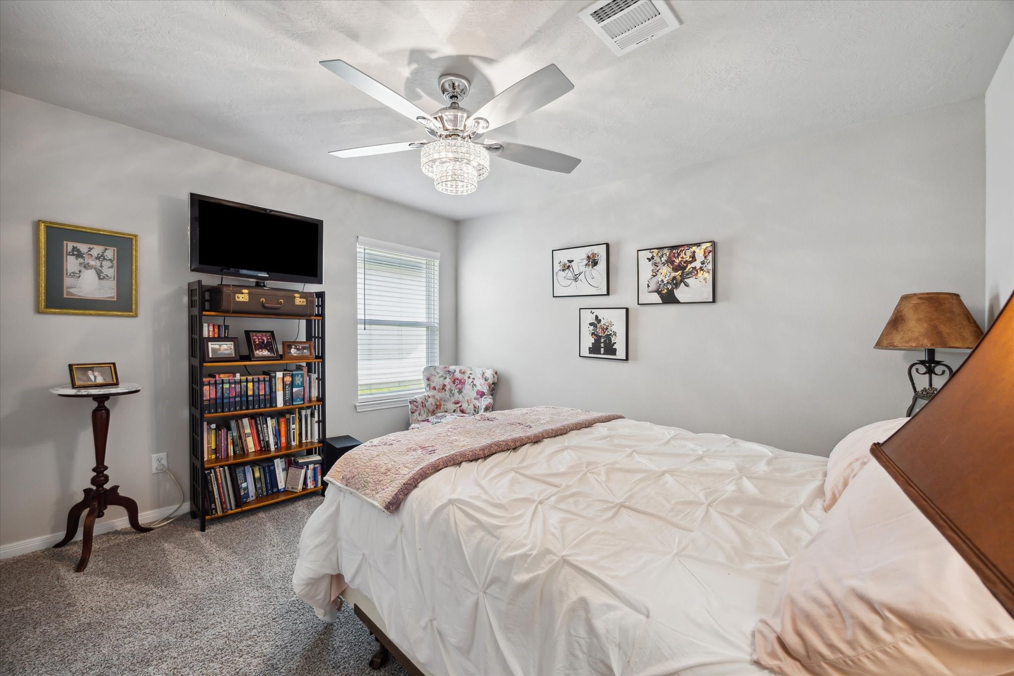 1010 Old Vine Road Brenham, TX 77833 - Photo 12 of 20 a spacious bedroom with a bed a window and a flat screen tv