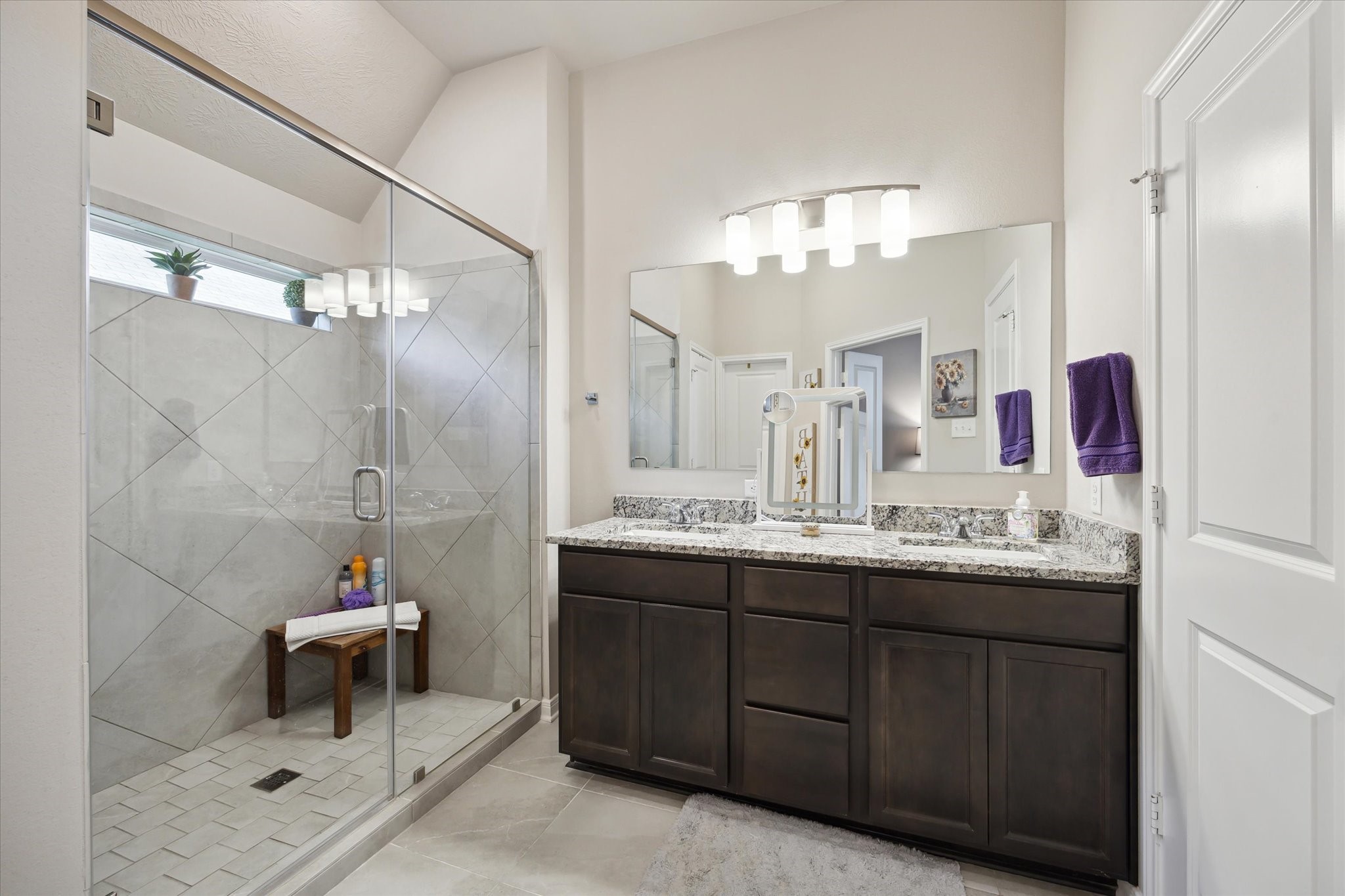 1010 Old Vine Road Brenham, TX 77833 - Photo 13 of 20 a bathroom with a double vanity sink mirror and shower