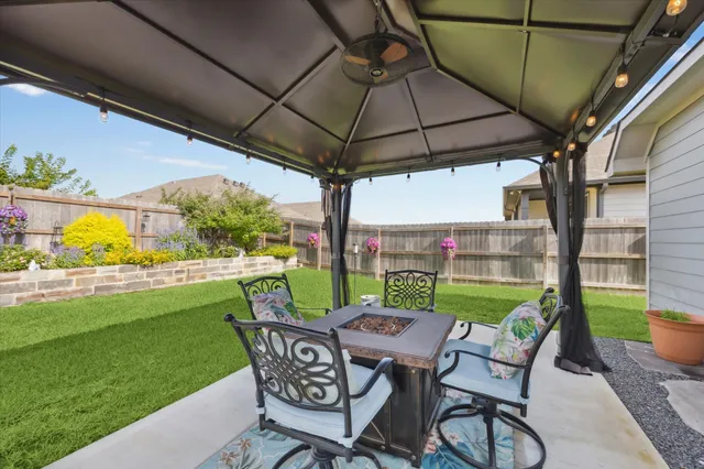 a view of an chairs and table in the patio