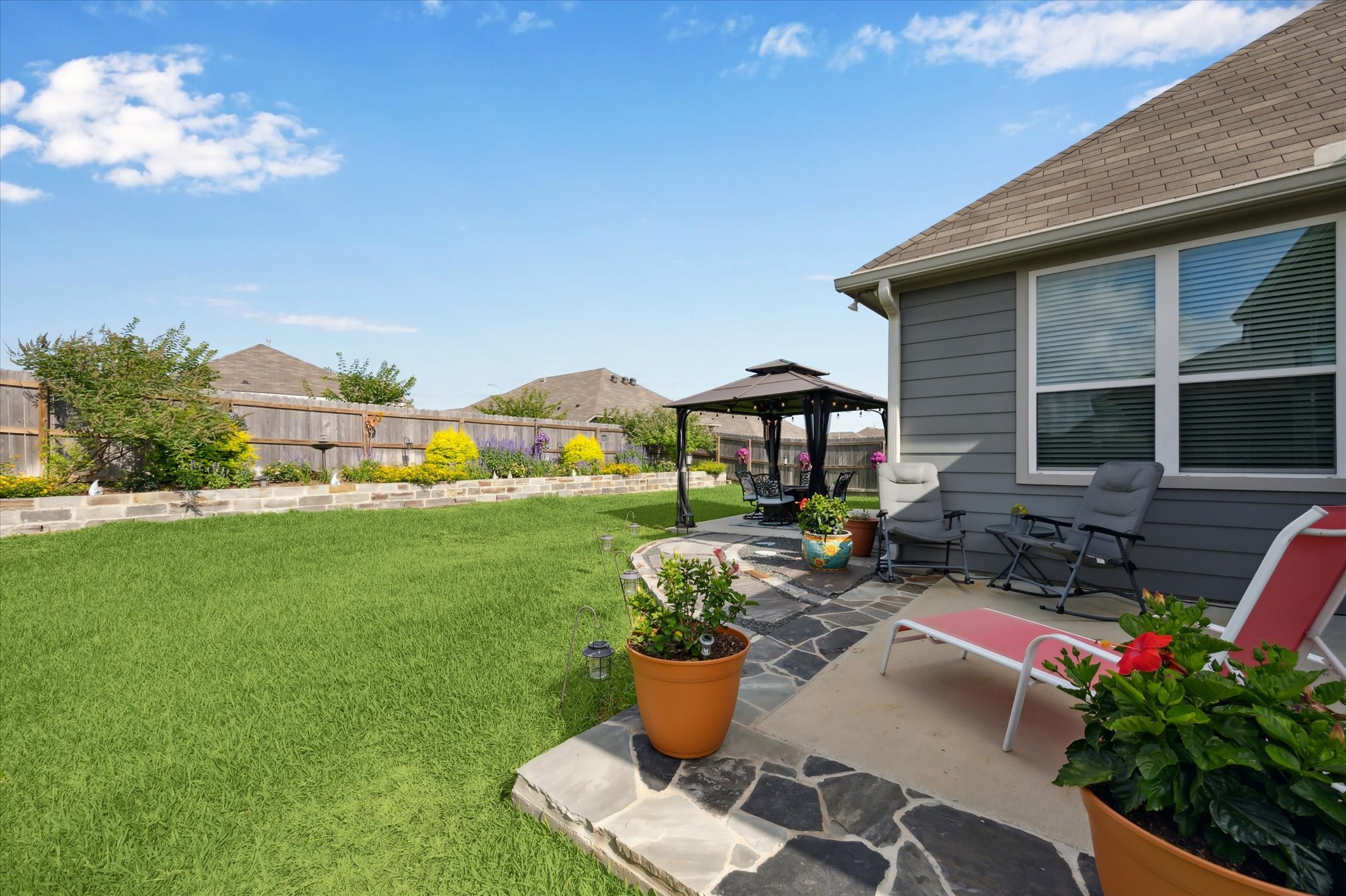 1010 Old Vine Road Brenham, TX 77833 - Photo 18 of 20 a view of a house with backyard sitting area and garden