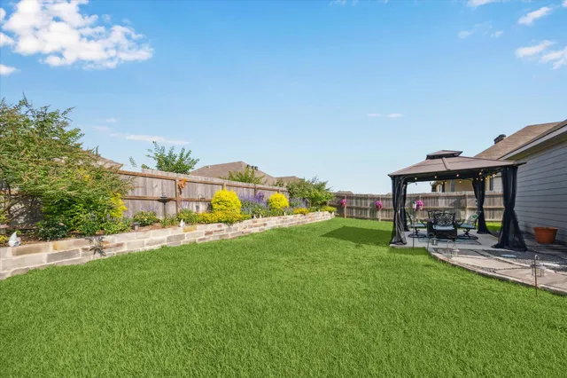 a view of a house with backyard porch and sitting area