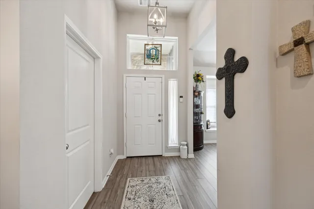 a view of hallway with wooden floor and stairs
