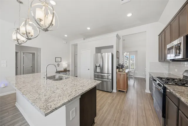a kitchen with refrigerator and stove