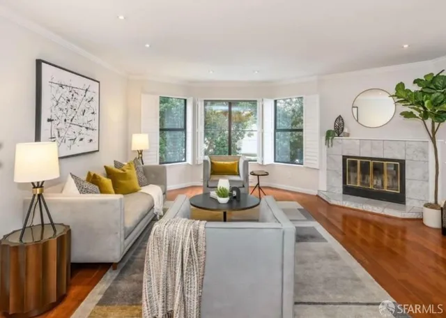 a living room with furniture a window and a fireplace