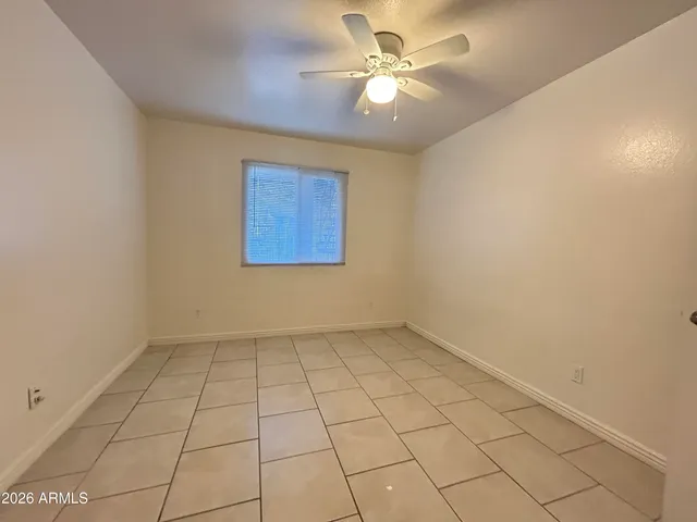 a view of a room with white walls and tiles