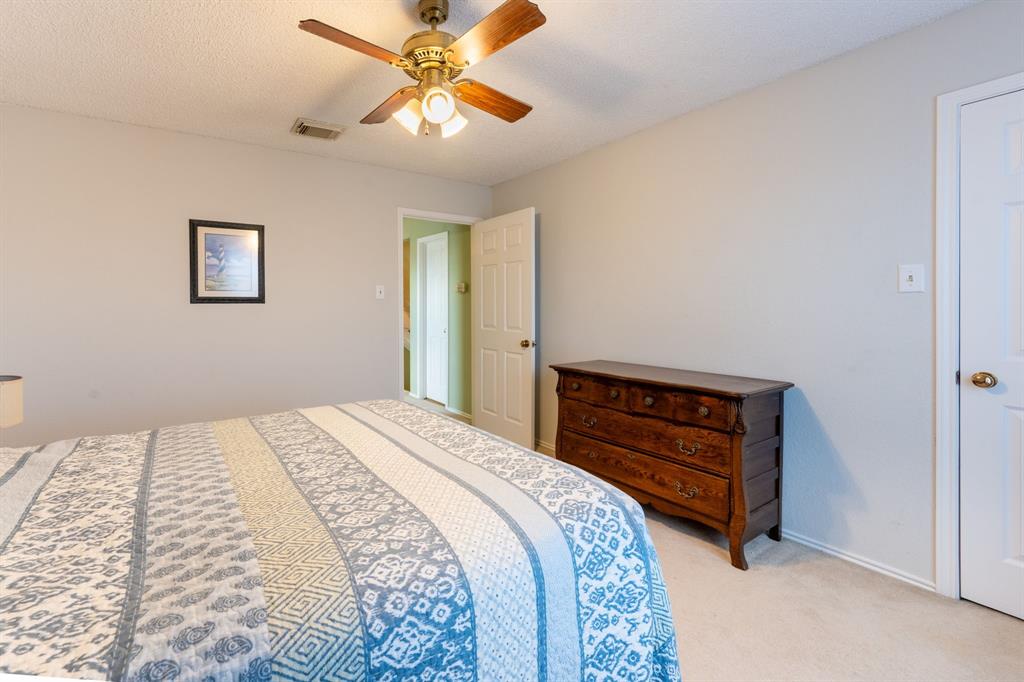 1611 Mission Ridge Trail Carrollton, TX 75007 - Photo 30 of 35 a bedroom with a bed and a chandelier