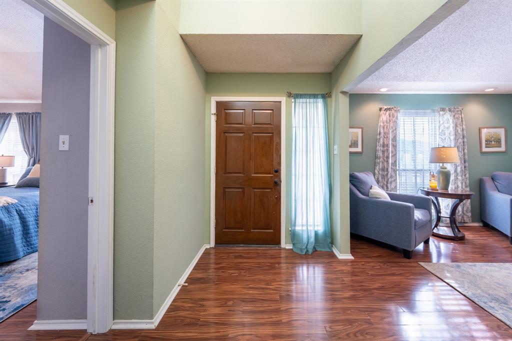1611 Mission Ridge Trail Carrollton, TX 75007 - Photo 3 of 35 a living room with furniture and a wooden floor