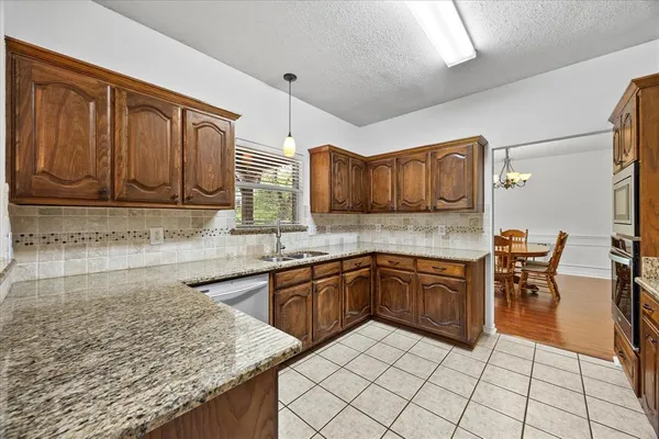 a kitchen with stainless steel appliances granite countertop a sink and cabinets