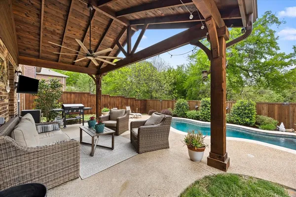 a building outdoor space with patio furniture and potted plants