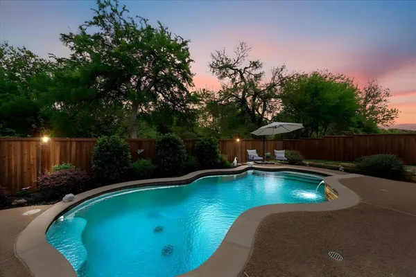 a view of a swimming pool and lounge chair