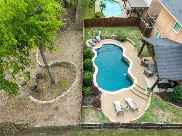 an aerial view of a house with a yard and lake view