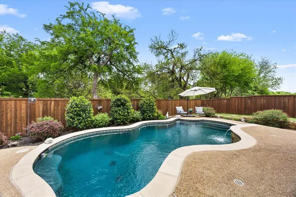 a view of a swimming pool and lounge chair