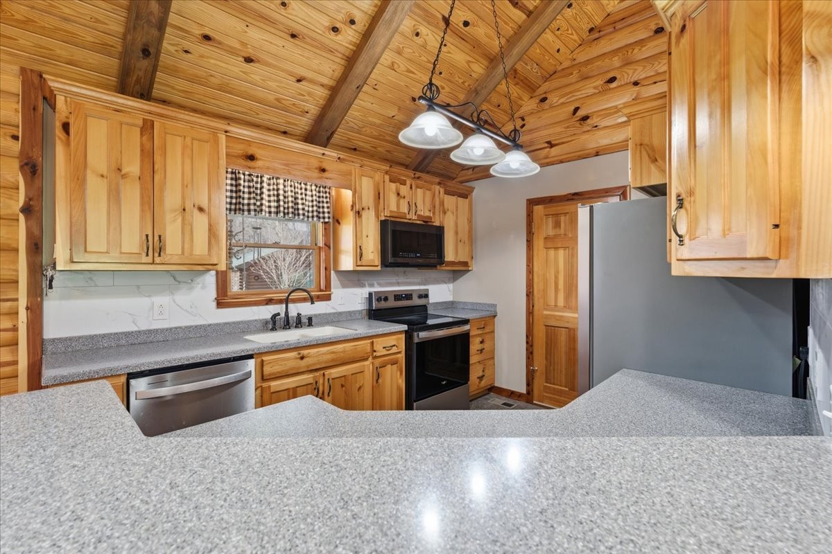 854 Holston Shores Drive Rutledge, TN 37861 - Photo 9 of 52 a kitchen with stainless steel appliances granite countertop a sink a stove and a refrigerator with wooden floor