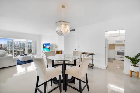 a view of a dining room with furniture wooden floor and chandelier