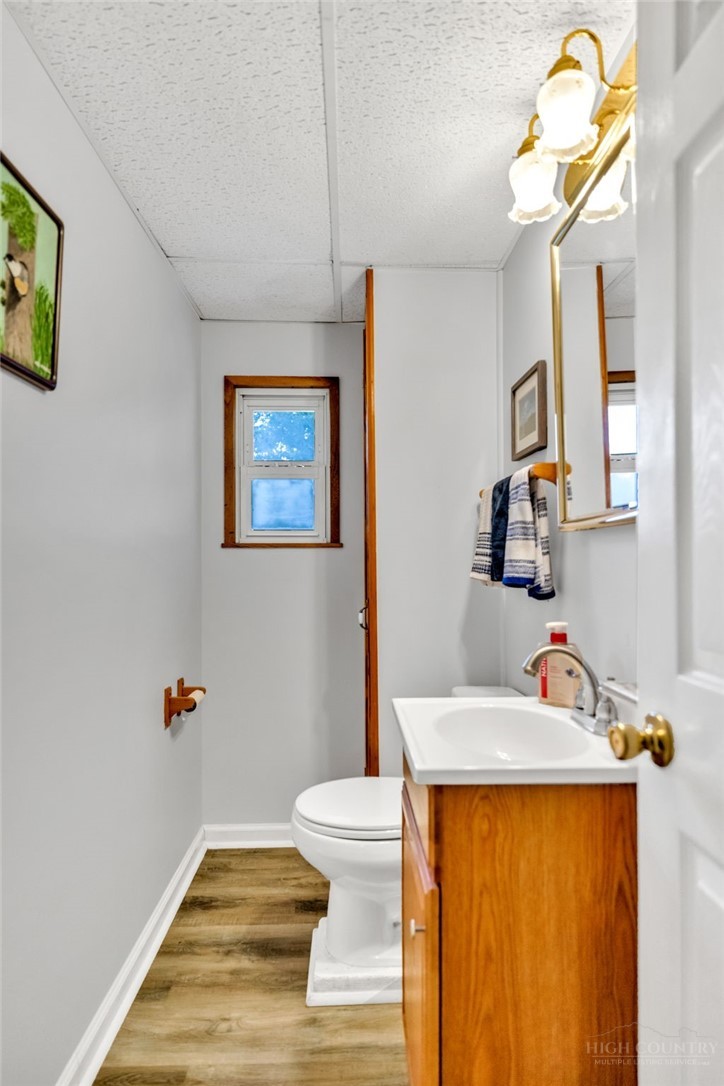 242 Ladd Parson Road Crumpler, NC 28617 - Photo 17 of 36 a bedroom with a bed and a chandelier