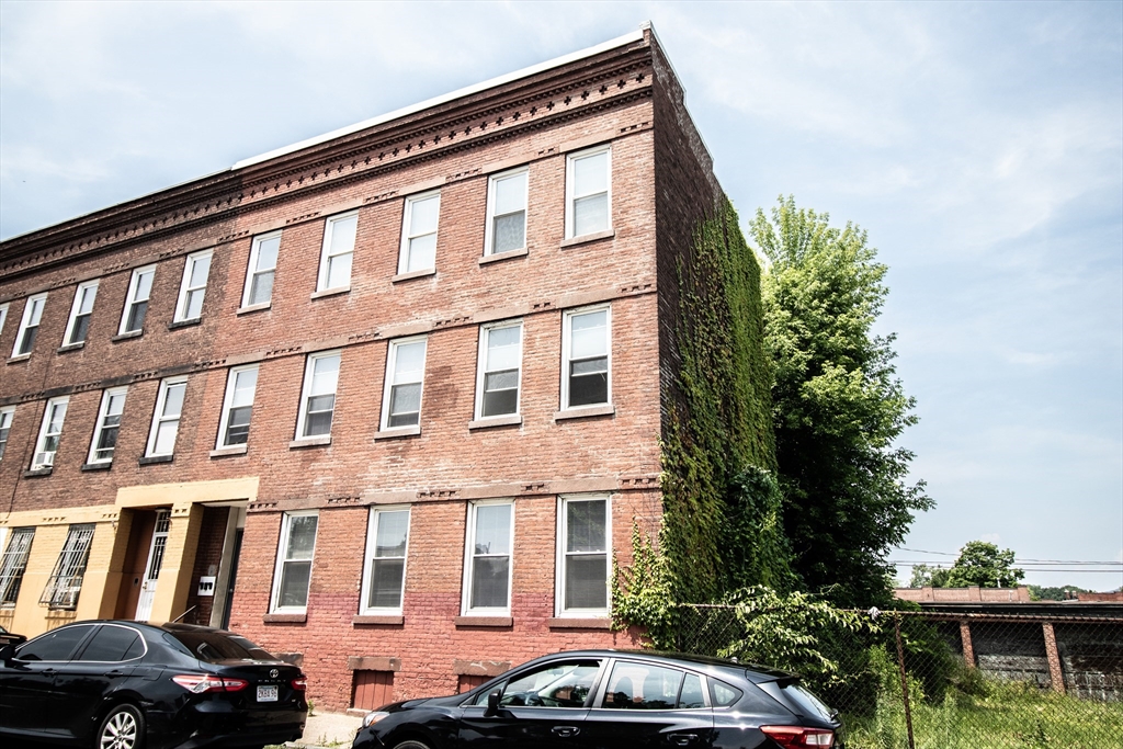 a front view of a building with parking space