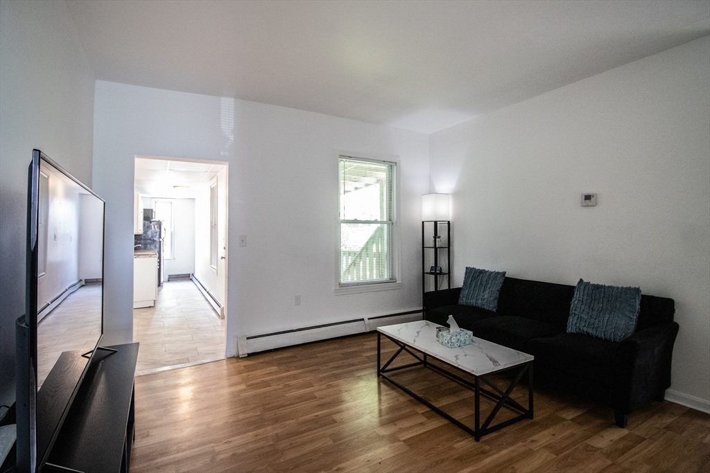 91 Elm Street Holyoke, MA 01040 - Photo 11 of 32 a living room with furniture and a wooden floor