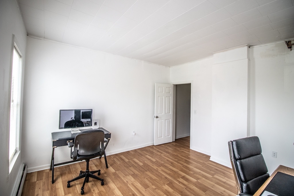 91 Elm Street Holyoke, MA 01040 - Photo 14 of 32 a view of a workspace with furniture and wooden floor