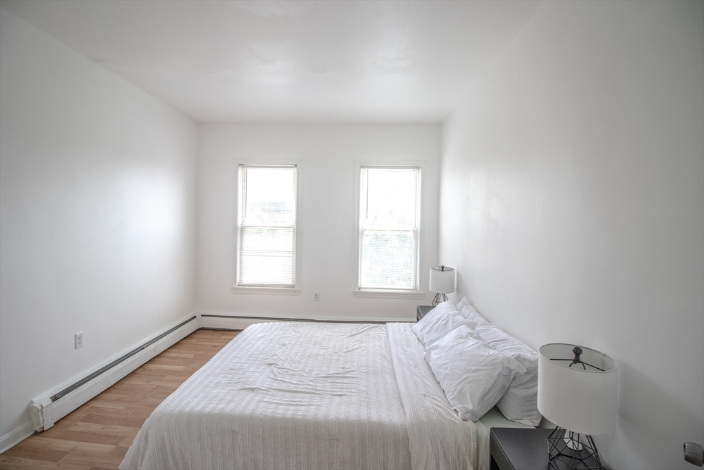 91 Elm Street Holyoke, MA 01040 - Photo 15 of 32 a bedroom with a bed and a window