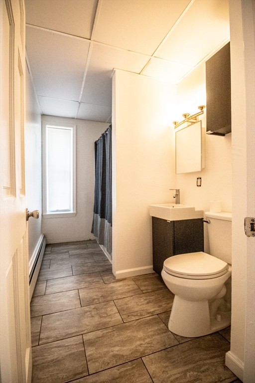 91 Elm Street Holyoke, MA 01040 - Photo 18 of 32 a bathroom with a toilet a sink and mirror