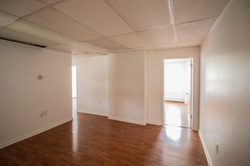 91 Elm Street Holyoke, MA 01040 - Photo 21 of 32 an empty room with wooden floor