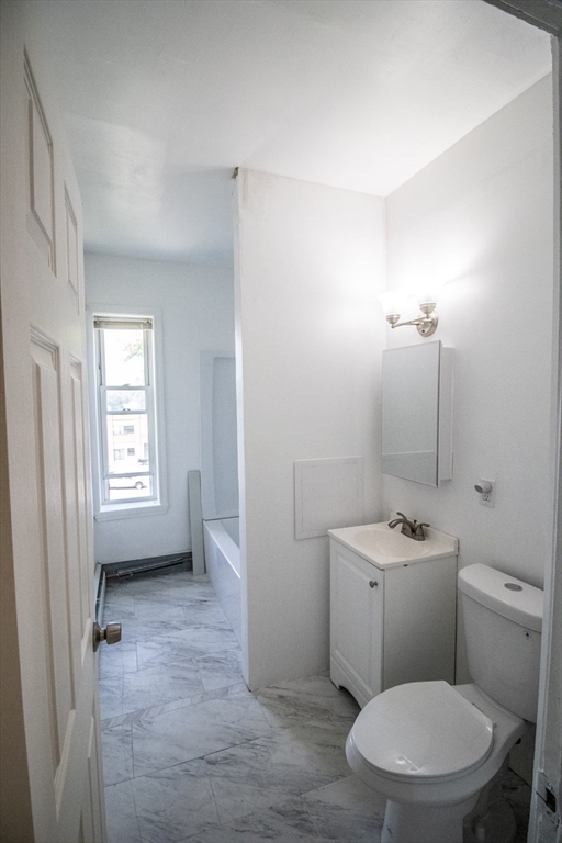 91 Elm Street Holyoke, MA 01040 - Photo 25 of 32 a white toilet sitting next to a bathroom sink