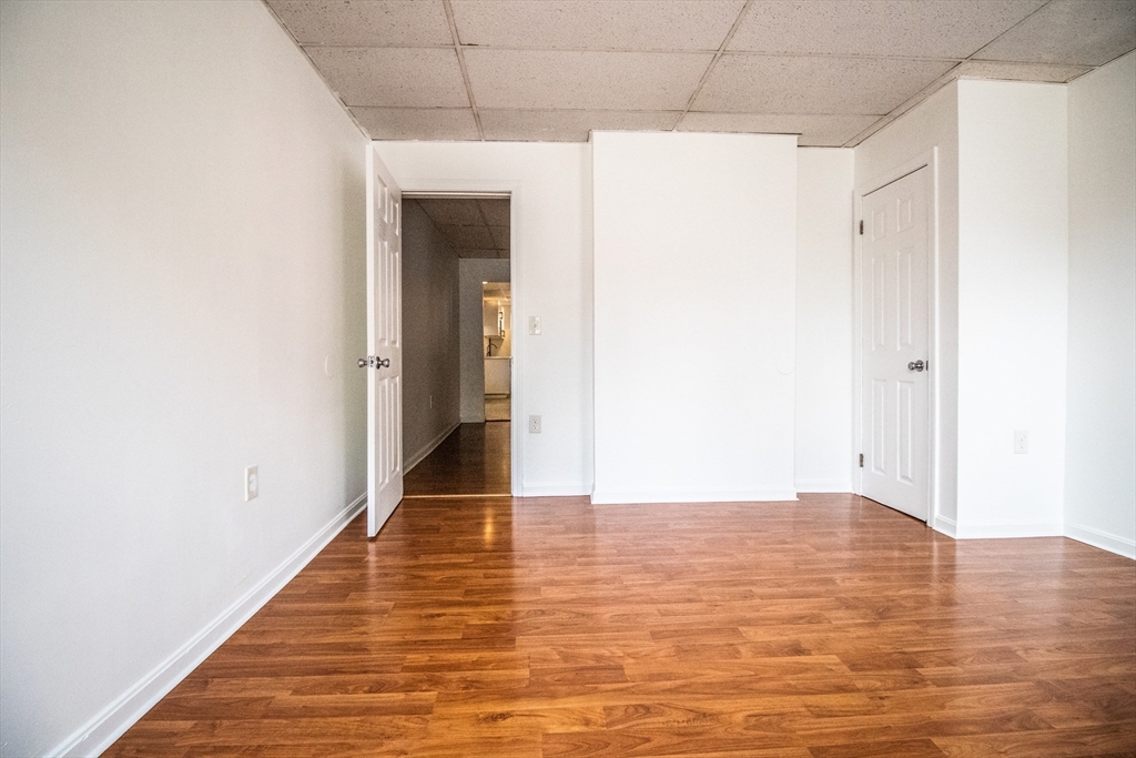 91 Elm Street Holyoke, MA 01040 - Photo 26 of 32 a view of a hallway with wooden floor