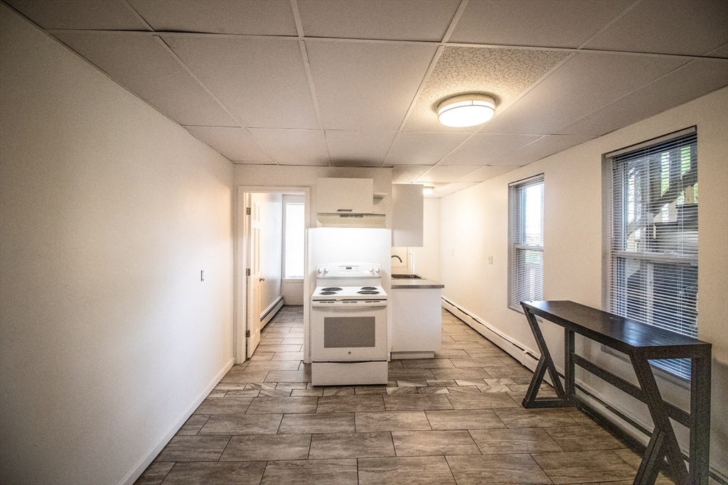 91 Elm Street Holyoke, MA 01040 - Photo 27 of 32 a kitchen with stainless steel appliances granite countertop a stove a sink and a refrigerator