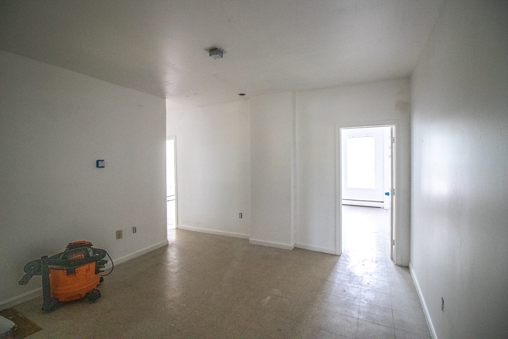 91 Elm Street Holyoke, MA 01040 - Photo 29 of 32 a view of empty room with wooden floor