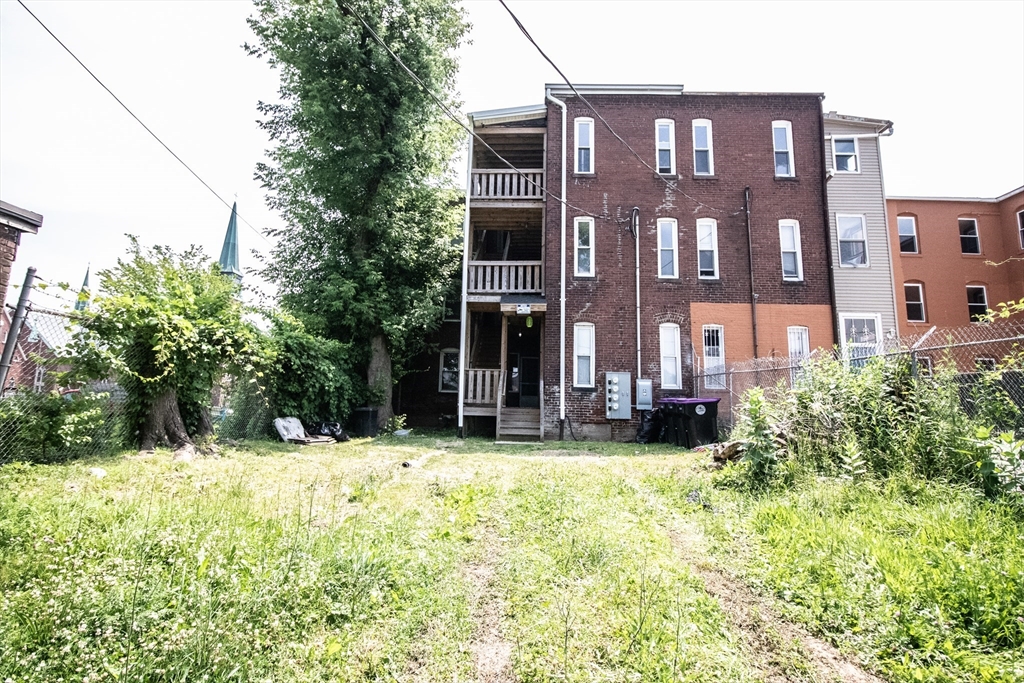 91 Elm Street Holyoke, MA 01040 - Photo 4 of 32 a view of a building with a yard