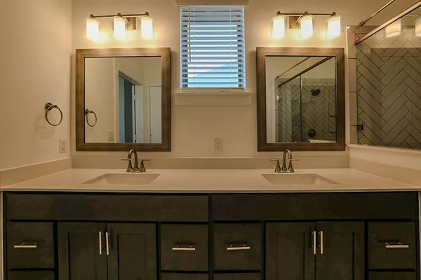 a bathroom with a double vanity sink and a mirror