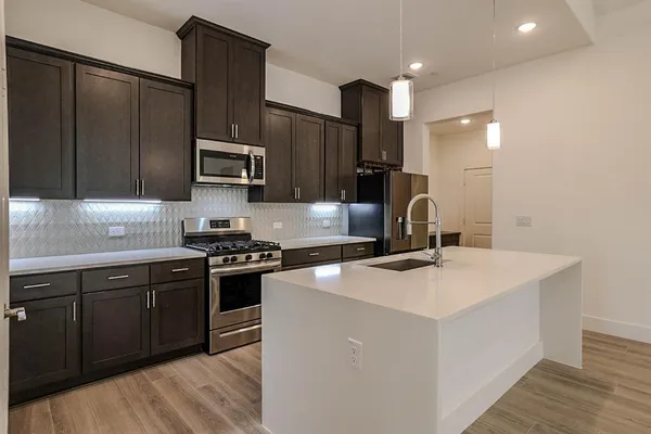 a kitchen with a sink a stove and refrigerator