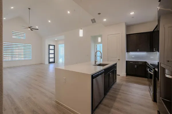 a kitchen with stainless steel appliances granite countertop a stove and a sink