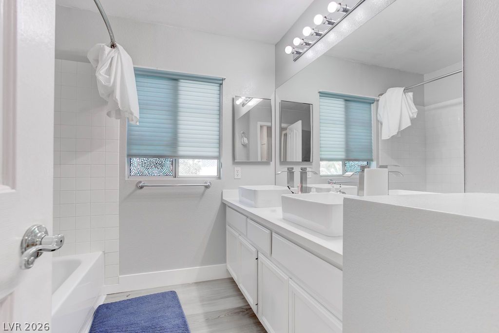 1 Rising Sun Court Henderson, NV 89074 - Photo 28 of 47 Dual vessel sinks and modern fixtures elevate this well-appointed bathroom.