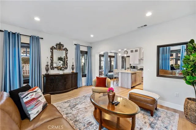 a living room with furniture and painting on the wall