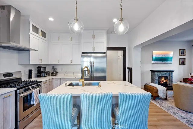 a kitchen with kitchen island a sink stainless steel appliances and cabinets