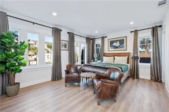 a bedroom with furniture and a potted plant