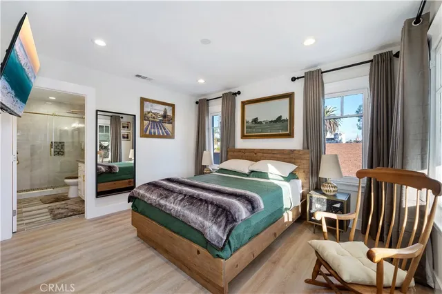 a bedroom with a bed and glass walk in closet