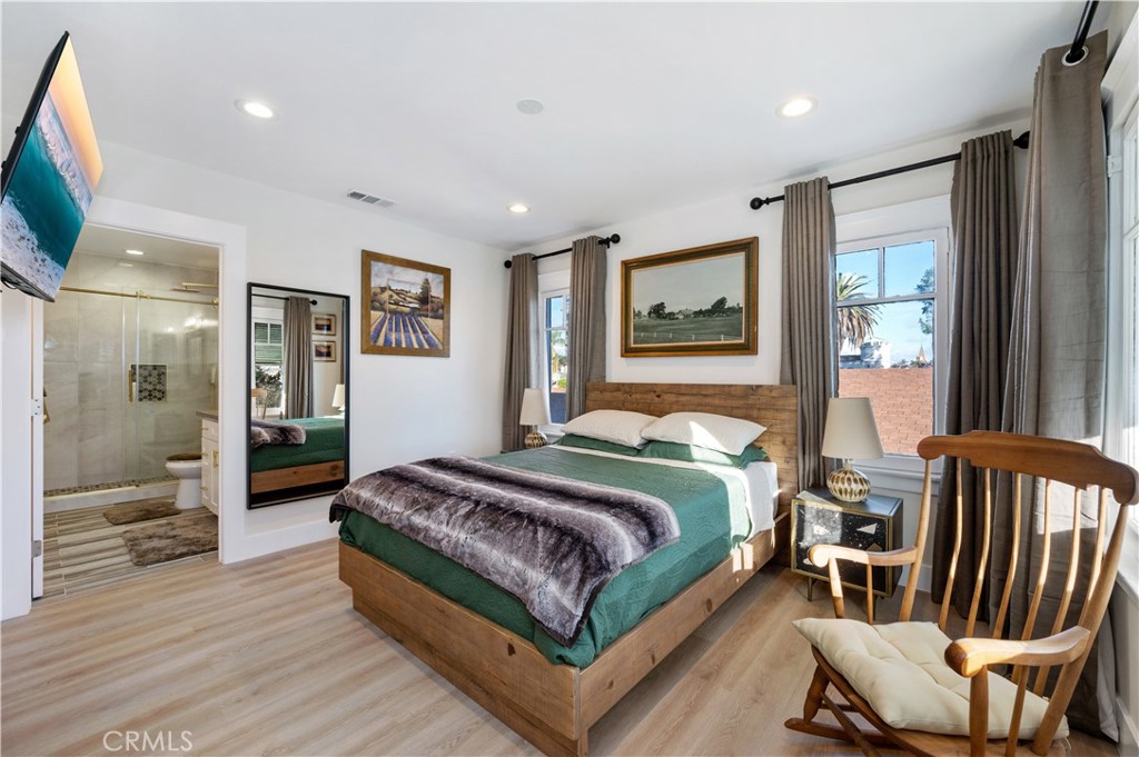 2920 East 7th Street Long Beach, CA 90814 - Photo 8 of 13 a bedroom with a bed and glass walk in closet