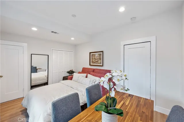 a bedroom with a bed and a painting on the wall