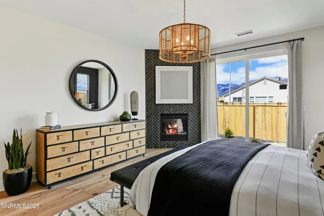 a bed sitting in a bedroom next to a window